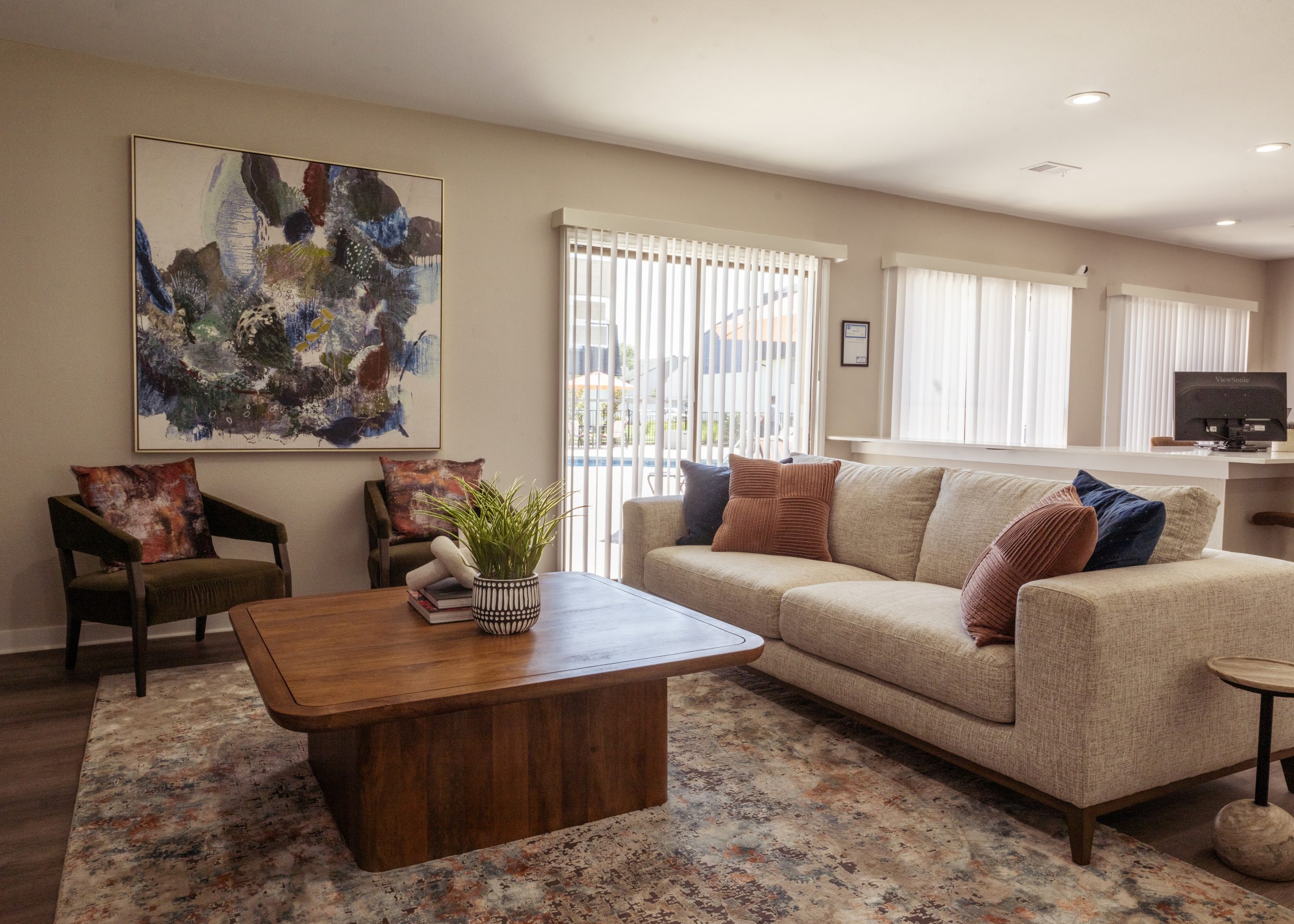 a living room filled with furniture and a large window