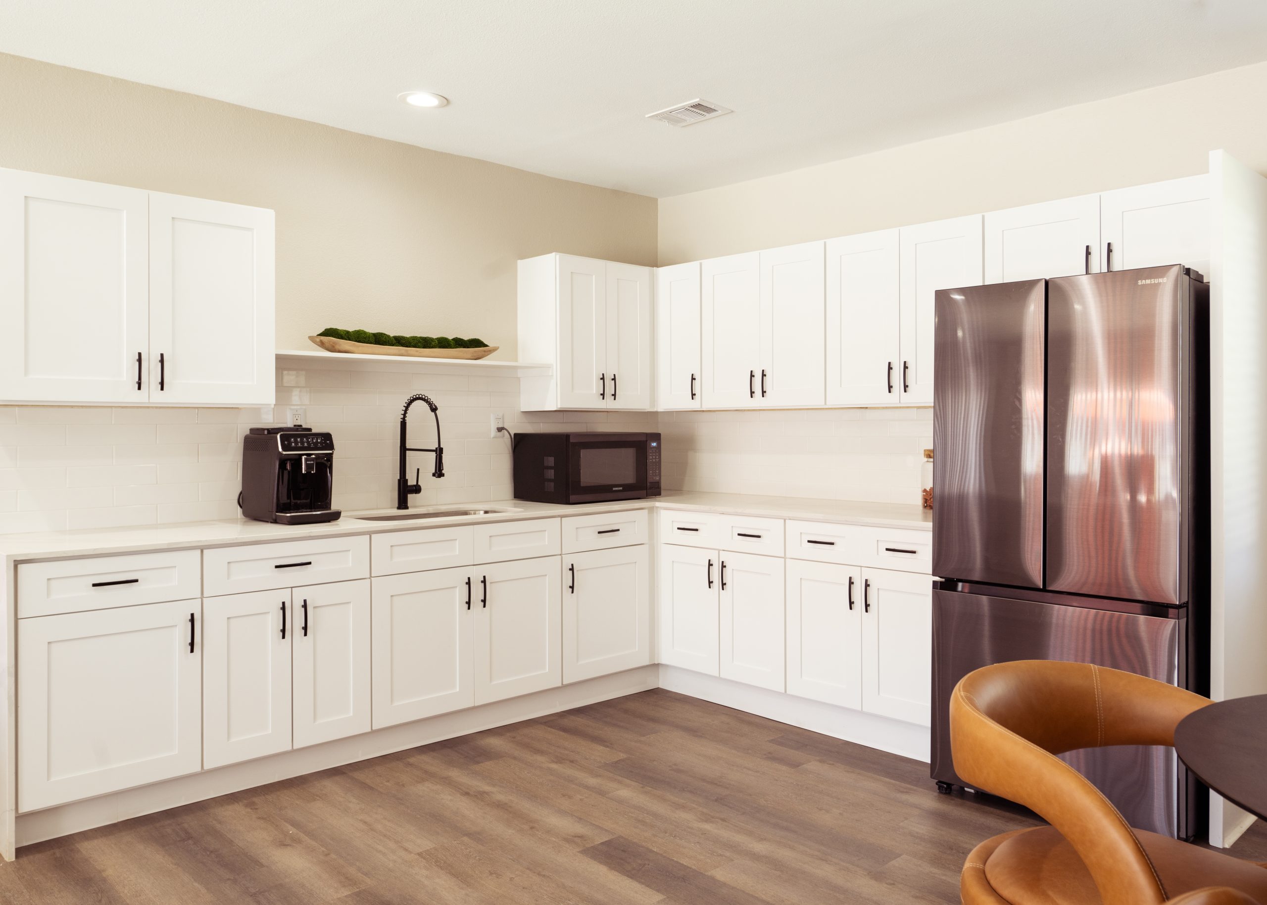 a kitchen with a refrigerator, stove, microwave, sink, and dishwasher